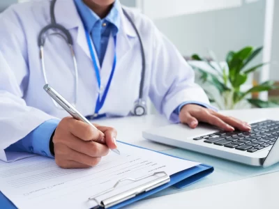 КАК ДА СЕ ПРЕДПАЗИМ ОТ ТЕЖКИТЕ БОЛЕСТИ? - I ЧАСТ - hands unrecognizable female doctor writing form typing laptop keyboard 1098 20374